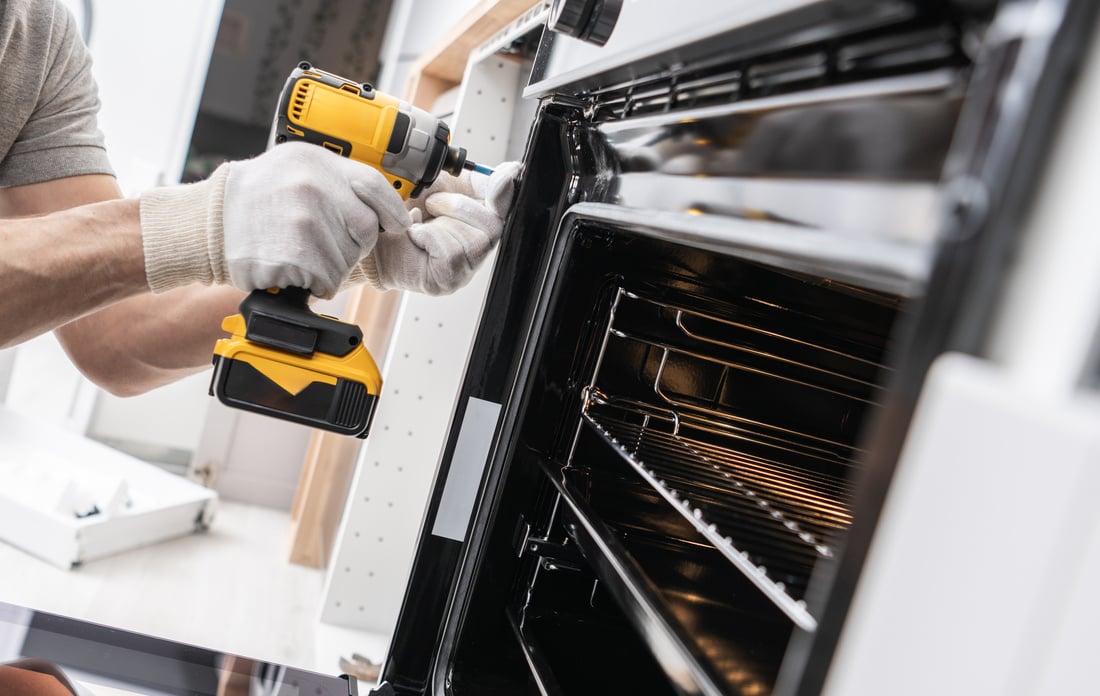 Home Appliances Technician Installing a Stove